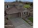 Two-story home featuring a front-facing two car garage, desert landscaping, and a brown tile roof at 12227 W Prickly Pear Trl, Peoria, AZ 85383