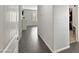 Hallway with hardwood floors that leads into a brightly lit room at 12227 W Prickly Pear Trl, Peoria, AZ 85383