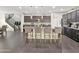 Stylish eat-in kitchen with dark cabinets, pendant lighting, and stainless steel appliances at 12227 W Prickly Pear Trl, Peoria, AZ 85383