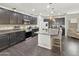 Spacious kitchen with dark cabinets, granite counters, stainless steel appliances, and a large island with seating at 12227 W Prickly Pear Trl, Peoria, AZ 85383