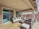 Relaxing covered patio features stylish wicker furniture and a seamless transition to indoor living at 12227 W Prickly Pear Trl, Peoria, AZ 85383