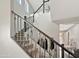 Carpeted staircase with rod iron spindles with bright lighting at 12227 W Prickly Pear Trl, Peoria, AZ 85383