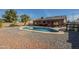 Backyard featuring a pool, covered patio, palm trees, and an outer wall at 1226 N Nevada Way, Mesa, AZ 85203