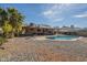 A serene backyard featuring a sparkling pool, solar panels, and desert landscaping at 1226 N Nevada Way, Mesa, AZ 85203