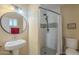 Bathroom featuring tiled shower, modern fixtures, and decorative recessed niche at 1226 N Nevada Way, Mesa, AZ 85203