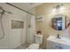 Bright bathroom featuring tiled shower, modern fixtures, and decorative recessed niche at 1226 N Nevada Way, Mesa, AZ 85203