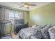Cozy bedroom with a ceiling fan and natural light, furnished with a comfortable bed and storage at 1226 N Nevada Way, Mesa, AZ 85203