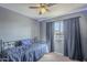 Relaxing bedroom featuring a twin bed, soft carpet, and a ceiling fan for added comfort at 1226 N Nevada Way, Mesa, AZ 85203