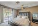 Bedroom featuring sliding glass doors, a ceiling fan, and stylish wall decor at 1226 N Nevada Way, Mesa, AZ 85203