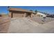 Single-story home featuring a two-car garage, gravel yard, and concrete driveway at 1226 N Nevada Way, Mesa, AZ 85203