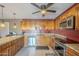 Modern kitchen with stainless steel appliances, tile flooring, and warm wood cabinetry at 1226 N Nevada Way, Mesa, AZ 85203