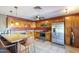 Well-equipped kitchen featuring updated stainless steel appliances, custom cabinets and a granite countertop island at 1226 N Nevada Way, Mesa, AZ 85203