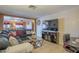 Comfortable living room featuring tile floors and an entertainment center with a large-screen TV at 1226 N Nevada Way, Mesa, AZ 85203