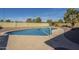Backyard with a sparkling swimming pool, basketball hoop, and mature trees at 1226 N Nevada Way, Mesa, AZ 85203