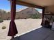 Covered patio overlooking the backyard with desert landscaping at 12565 W Amelia Ave, Avondale, AZ 85392