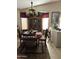 Traditional dining room with wood table, decorative hutch, and natural lighting at 12565 W Amelia Ave, Avondale, AZ 85392