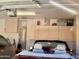 Spacious garage with ample storage cabinets and overhead lighting at 12565 W Amelia Ave, Avondale, AZ 85392