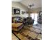 Cozy living room featuring comfortable seating, ceiling fan, and a decorative patterned rug at 12565 W Amelia Ave, Avondale, AZ 85392