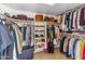 Organized walk-in closet with shelving and hanging space for clothes and accessories at 12809 E Sahuaro Dr, Scottsdale, AZ 85259