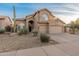 Charming two-story home with three-car garage and desert landscaping at daytime at 12809 E Sahuaro Dr, Scottsdale, AZ 85259