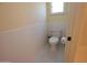 Well-lit bathroom featuring a classic white toilet, white-tiled walls, and hexagonal floor tiles at 1301 E Sheridan St, Phoenix, AZ 85006