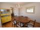 Bright dining room featuring hardwood floors, a chandelier, and a yellow china cabinet at 1301 E Sheridan St, Phoenix, AZ 85006