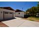 Exterior view of a home featuring a detached garage, long driveway, and well-kept yard at 1301 E Sheridan St, Phoenix, AZ 85006
