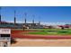 Expansive view of the North High School football field with stadium seating, goalposts, and clear blue skies above at 1301 E Sheridan St, Phoenix, AZ 85006