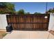 Secure wooden gate with automated opener, providing privacy and access control to the property at 1301 E Sheridan St, Phoenix, AZ 85006