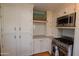 Well-equipped kitchen showcasing stainless steel appliances and white cabinetry at 1301 E Sheridan St, Phoenix, AZ 85006