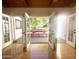 View of the patio through open french doors, showing a red picnic table and lush greenery at 1301 E Sheridan St, Phoenix, AZ 85006