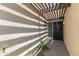 Close-up of the front entrance with a pergola that provides shade to the entryway at 1360 E Brown Rd # 9, Mesa, AZ 85203