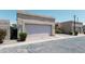 Front view of a single-story home showcasing the garage and desert-style landscaping for low maintenance at 1360 E Brown Rd # 9, Mesa, AZ 85203