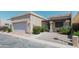 Charming single-story home with a two-car garage, desert landscaping, and inviting pergola-covered entrance at 1360 E Brown Rd # 9, Mesa, AZ 85203