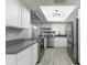 Modern kitchen with stainless steel appliances, white cabinets, and sleek countertops under a skylight at 1360 E Brown Rd # 9, Mesa, AZ 85203