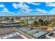 Scenic aerial view of the tennis courts, lake, and surrounding community under a bright blue, partly cloudy sky at 13640 N Del Webb Blvd, Sun City, AZ 85351