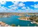 Picturesque aerial view of the community lake and surrounding neighborhood under a bright blue, partly cloudy sky at 13640 N Del Webb Blvd, Sun City, AZ 85351