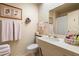 Bright bathroom featuring a marble sink, a large mirror, and a full bath with shower at 13640 N Del Webb Blvd, Sun City, AZ 85351