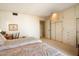Bright bedroom featuring two twin beds, large closets, and a built-in storage area at 13640 N Del Webb Blvd, Sun City, AZ 85351