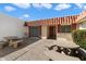 Enclosed courtyard featuring neutral stucco walls and multiple stone picnic tables at 13640 N Del Webb Blvd, Sun City, AZ 85351