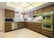 Cozy kitchen featuring wood cabinets, stainless steel appliances, and an overhead lighting system at 13640 N Del Webb Blvd, Sun City, AZ 85351