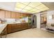 Functional kitchen featuring wood cabinets, stainless steel appliances, and ample counter space at 13640 N Del Webb Blvd, Sun City, AZ 85351