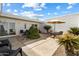 Charming private patio featuring neutral pavers and a cozy seating area with an umbrella for shade on sunny days at 13640 N Del Webb Blvd, Sun City, AZ 85351