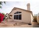 Backyard with a large covered patio, desert landscaping and a partial view of the neighborhood at 14130 W Bent Tree Cir, Litchfield Park, AZ 85340