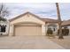 Inviting single-story home with a tile roof, two-car garage and desert landscaping at 14130 W Bent Tree Cir, Litchfield Park, AZ 85340