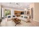 Bright living room with a seamless flow into the kitchen and access to outdoor patio at 14130 W Bent Tree Cir, Litchfield Park, AZ 85340