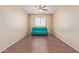 Bedroom with hardwood floors, a window, and a turquoise futon at 14369 W Caribbean Ln, Surprise, AZ 85379