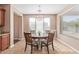 Bright dining area features a round table and modern chandelier, great for Gathering meals at 14369 W Caribbean Ln, Surprise, AZ 85379