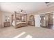 Spacious main bedroom with neutral carpet, four poster bed, and decorative furniture at 14369 W Caribbean Ln, Surprise, AZ 85379