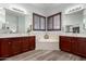 Bright bathroom features double sinks, a soaking tub, and wood-look floors at 15062 W Windward Ave, Goodyear, AZ 85395